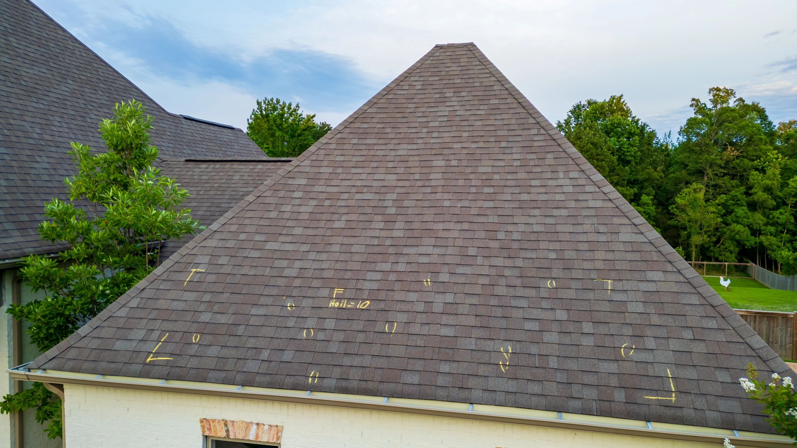 Close view of roof damage markings representing condition documentation for claims